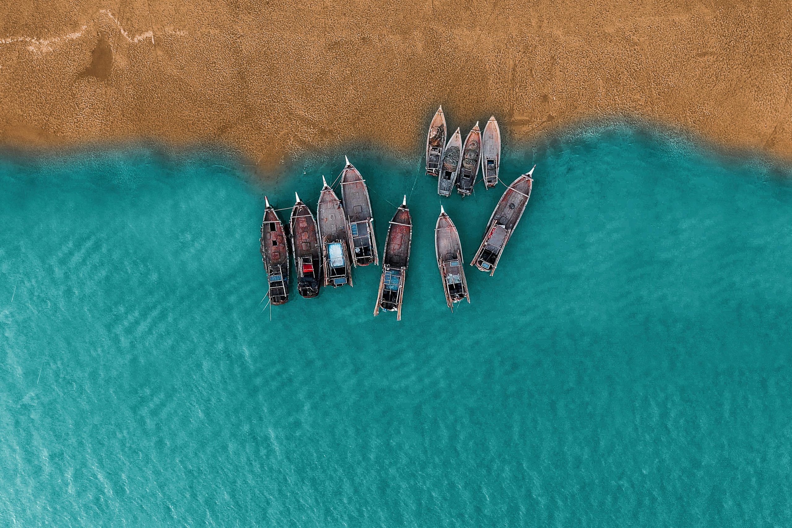 Aerial shot of fishing boats moored on sandy beach at Cox's Bazar, Bangladesh.